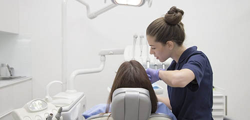 Dental Hygiene Student Works on a New Patient