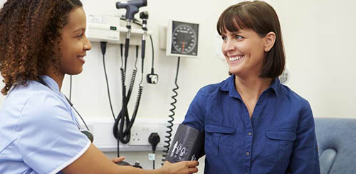 A Nursing Student Takes a Patients Blood Pressure