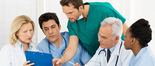 A Group of Nurses go over a Patients Chart